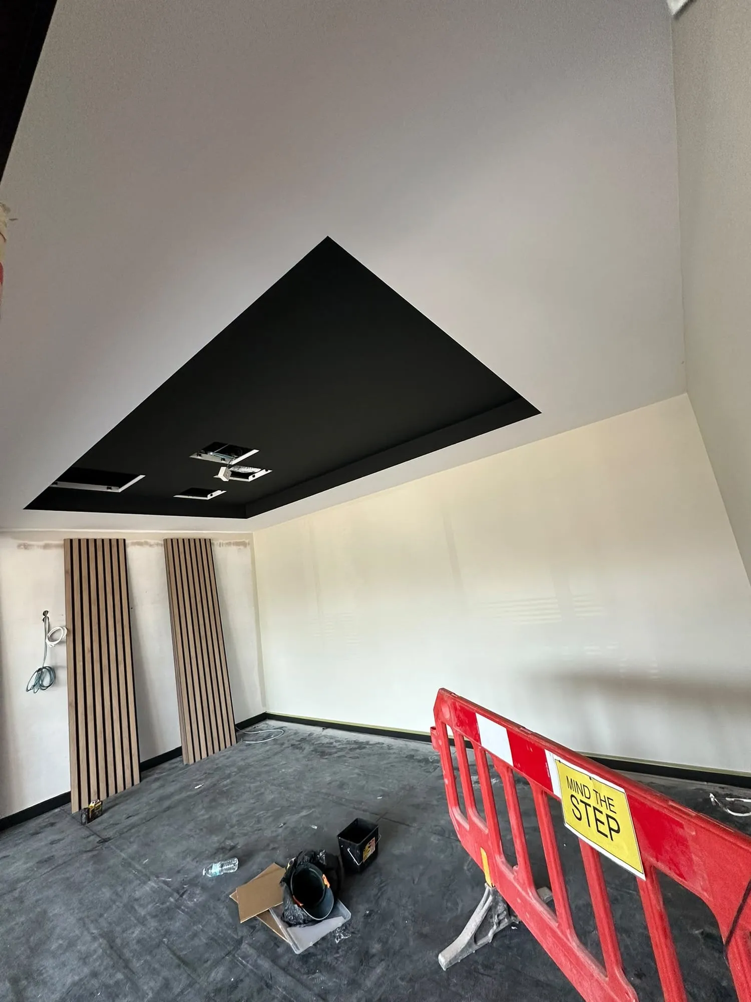 Finished room with a dark recessed ceiling and smooth jointed walls, ready for the fit-out